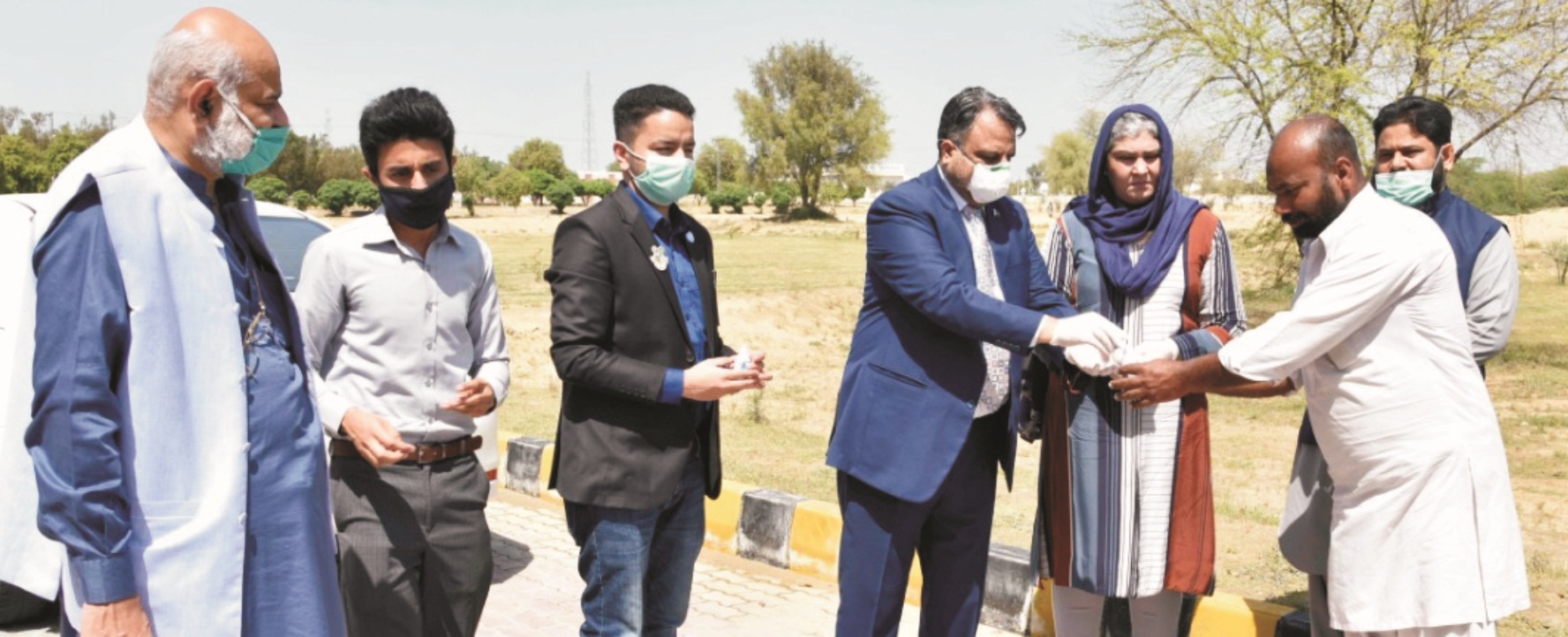 Worthy Vice Chancellor distributing hand sanitizers among on duty employees